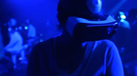 An Old Woman using Virtual Reality glasses at technology show Stock Footage 54937242