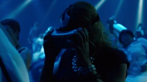 An Old Woman using Virtual Reality glasses at technology show Stock Footage 76223457