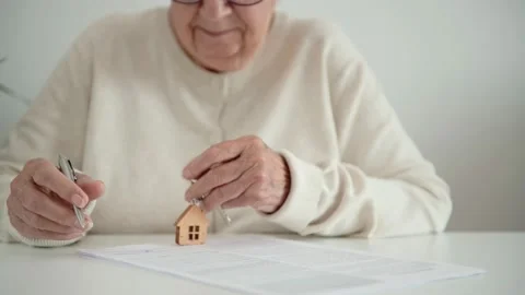 Old woman writes notes with trembling hand takes off glasses Stock Footage 164221532