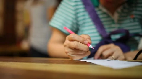 Old woman writing on paper Stock Footage