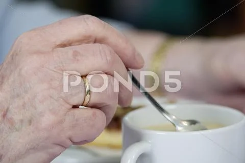 Old Woman\'s Hand Stirring In A Cup Of Coffee, Germany, Europe