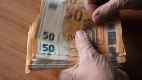 Old Woman's Hands Counting a Stack of 50 Euro Bills Stock Footage 258634628