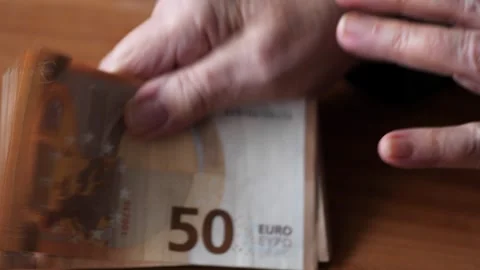 Old Woman's Hands Counting a Stack of 50 Euro Bills Stock Footage 258634876