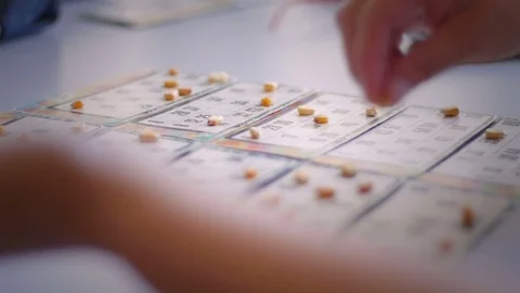 Old woman's hands playing bingo 스톡 동영상 76558205