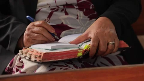 Old woman's hands with a ring write something in notebook with blue pen close up Stock Footage 215145359