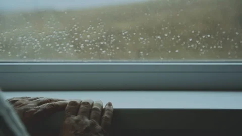 The old woman's hands on the window sill to which the cup is placed and the Stock Footage 125474345