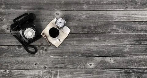 Old wood desk table with basic retro work items plus coffee in flat lay Stock Photos