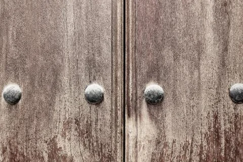 Old wood texture with natural patterns. Worn, weathered wooden gate with meta Stock Photos