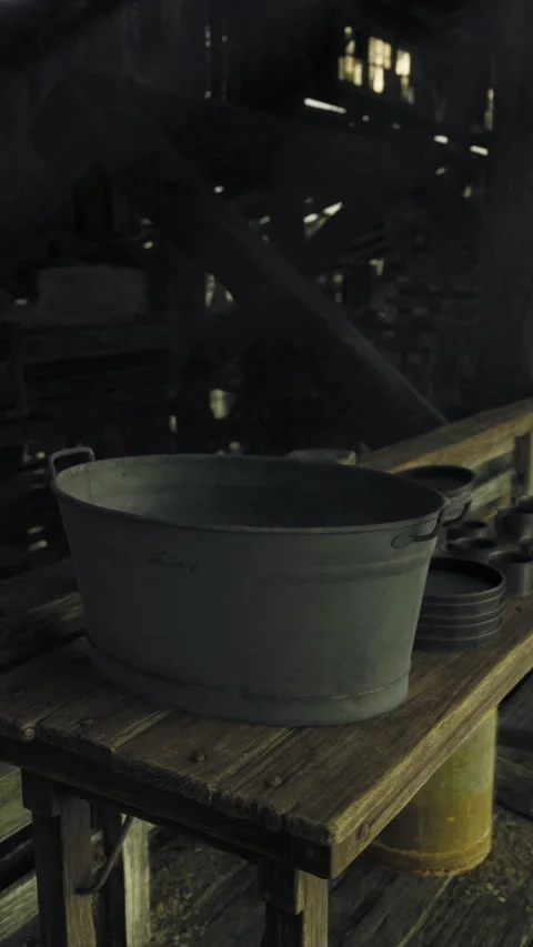 Old wooden barn interior featuring a metal container and rustic utensils Stock Footage 325076257