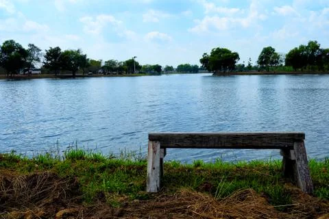 Old Wooden Bench at the Lake. Stock Photos