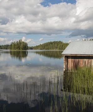 Old wooden boathouse, made of logs , at lake Etelä-Konnevesi, Finland Stock Photos