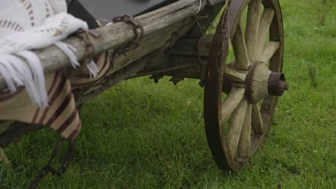 Old wooden cart wheel at sand beach. Cinematic shot for film Stock Footage 202015953