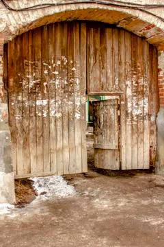 Old wooden gate in a dilapidated warped village Stock Photos