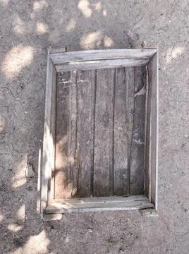 An old wooden rectangular small box lies on the ground Stock Photos