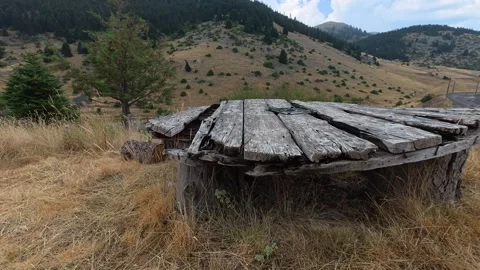 Old Wooden Round Table Made From Logs In Alpine Meadow During Rainy Autumn Video stock 327669782