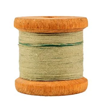 Old wooden spool of thread on a white background close-up. Threads for sewing Foto stock