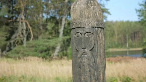 An old wooden statue of Slavic culture stands. God of thunder in mythology. Stock Footage