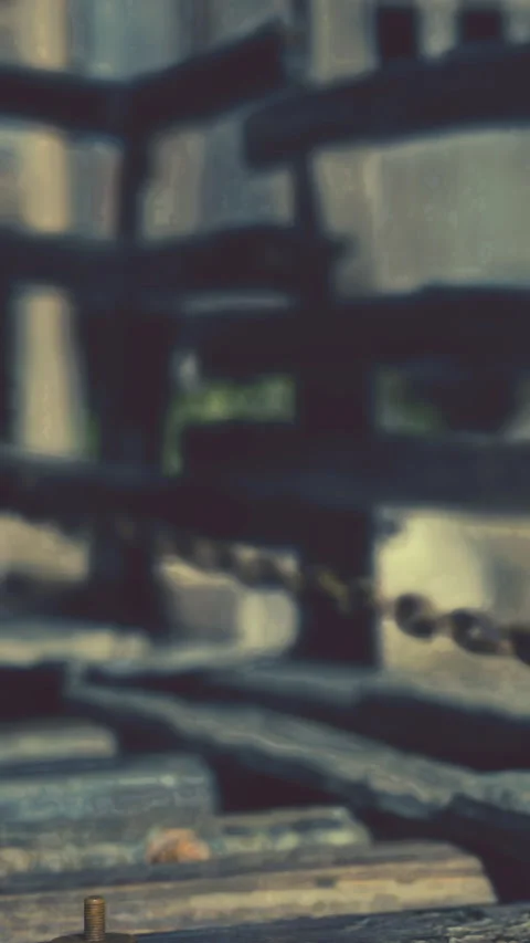 Old wooden structure with chain and screws in a quiet outdoor setting Stock Footage 337972578