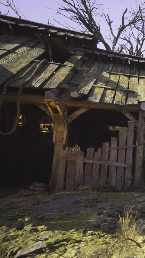 Old wooden structure with mossy ground under a clear blue sky Stock Footage 340080050