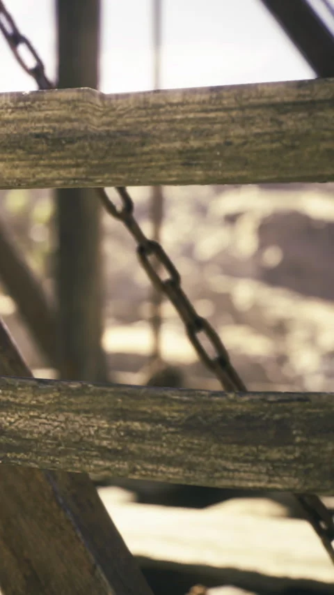 Old wooden structure with a rustic chain revealing peaceful surroundings Stock Footage 331803540