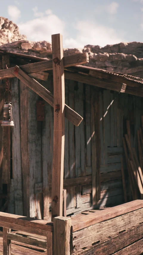 Old wooden structures stand in a dusty area under a clear sky Video stock 339774041