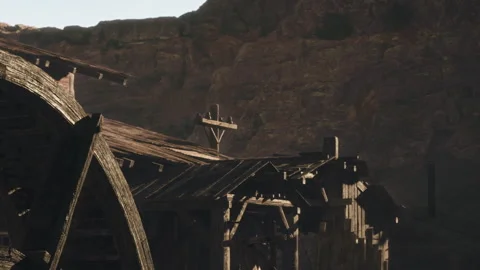 Old Wooden Structures Stand Majestically Against a Rugged Mountain Backdrop Stock Footage 344823612