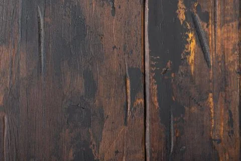 Old wooden surface background, scuffed boards with black paint stains. Stock Photos
