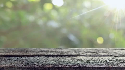 Old wooden table with soft sunlight and natural bokeh background Stock Footage 328235032