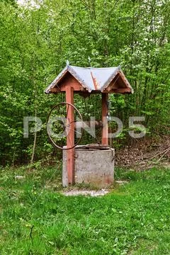 An old wooden well in the forest Stock Photos