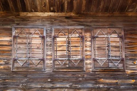 Old wooden windows with closed shutters Stock Photos