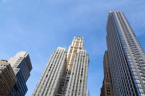 The old woolworth building between other skyscrapers in new york with blue sk Stock Photos
