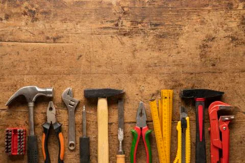 Old work hand tools on a vintage wooden background Foto stock