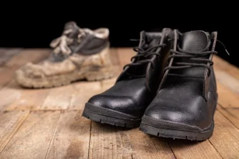 Old work shoe. New work shoes for production workers. Stock Photos