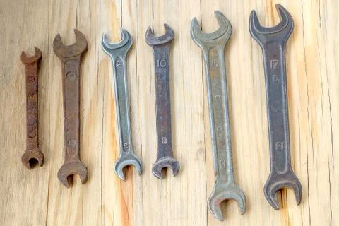 Old work tools spanner, wrench on a wooden table. Stock Photos