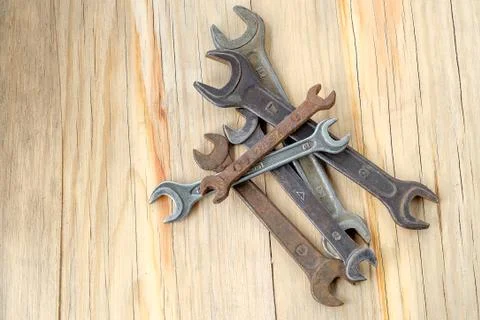 Old work tools spanner, wrench on a wooden table. Stock Photos