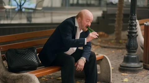 Old worker drinking alcohol from bottle after work showing addiction Stock Footage 318879526