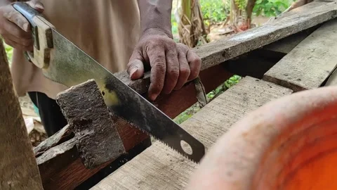 Old worker installing wooden planks to create a traditional house outdoor room 動画素材 255670893
