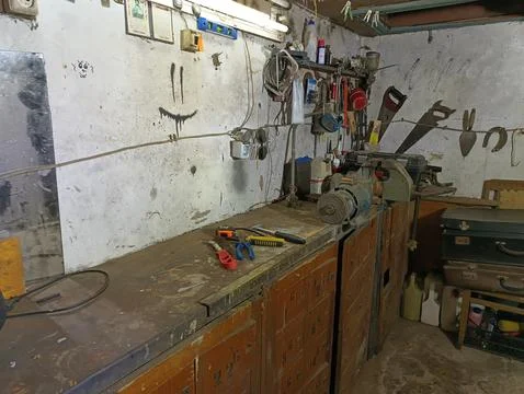 Old workshop with tools and equipment on workbench Stock Photos