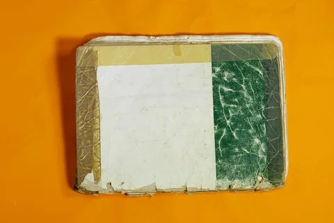 Old Worn Book on Yellow Surface Depicting Rustic and Vintage Sentiments Stock Photos