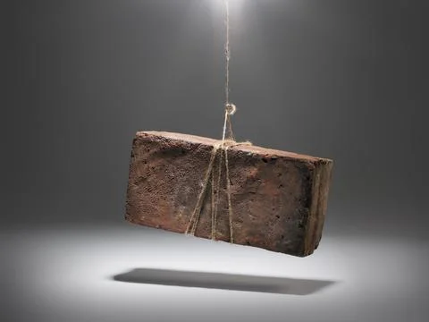 An old worn brick dangling from a string Stock Illustration