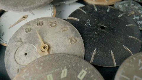 Old worn clock dials. Aged scratched round watch faces with hands and numbers Stock Photos