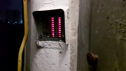 Old worn intercom with red buttons on the wall of the entrance door, background Stock-Footage 297255023