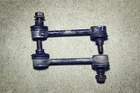 Old worn links stabilizer on a gray background Stock Photos