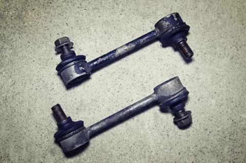 Old worn links stabilizer on a gray background Stock Photos
