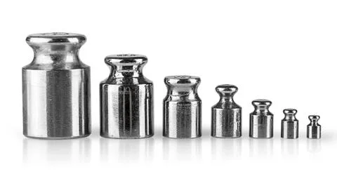 Old worn measuring weights in a row Stock Photos