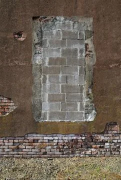 Old worn out brick wall with plaster partly covering them up. Stock Photos