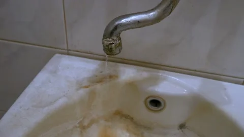 Old, worn out, leaking water tap covered with deposits of limescale and fungi Stock Footage 218173883