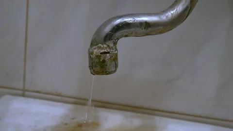 Old, worn out, leaking water tap covered with deposits of limescale and fungi Stock Footage 218174255