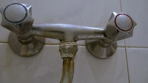 Old, worn out, leaking water tap covered with deposits of limescale and fungi Stock Footage 218174415