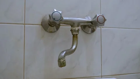 Old, worn out, leaking water tap covered with deposits of limescale and fungi Stock Footage 218174756